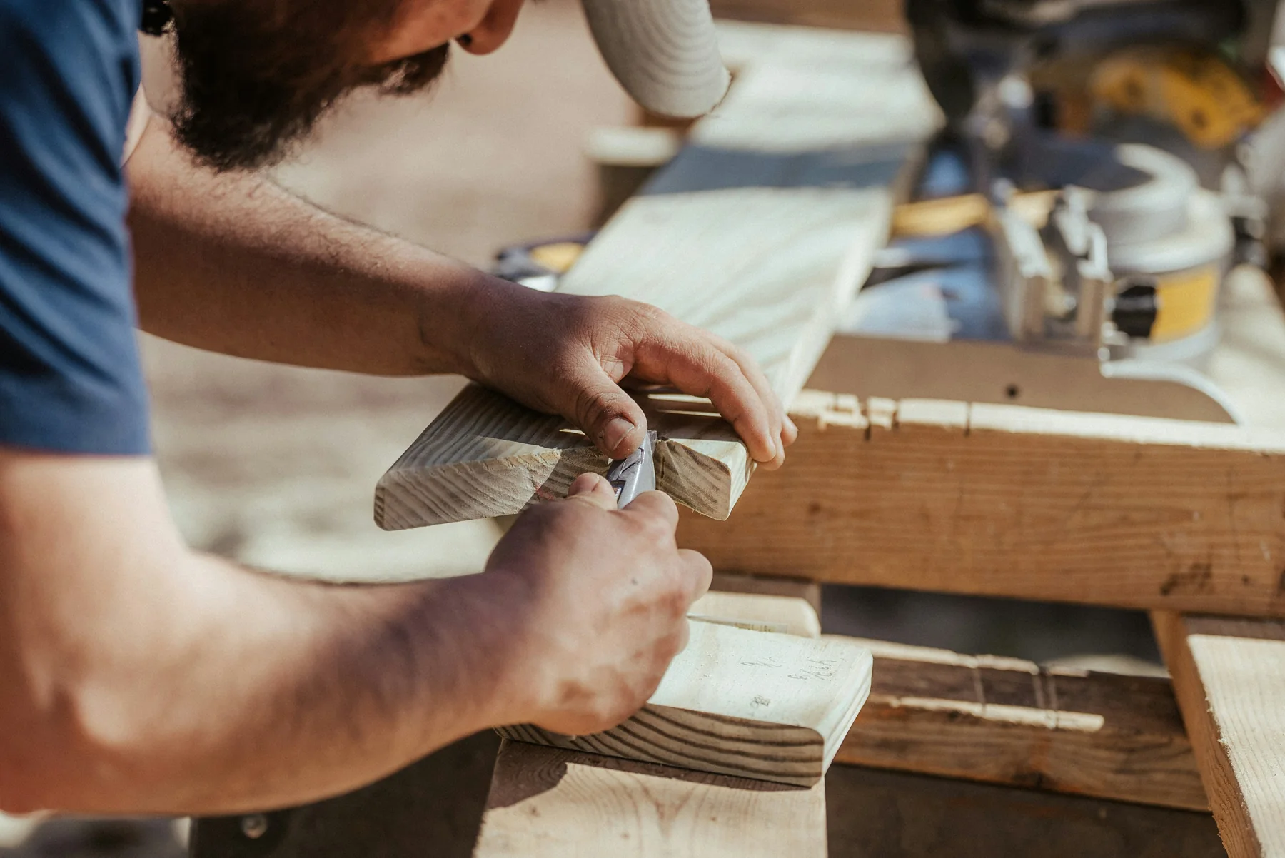 Craftsperson shaping timber by hand