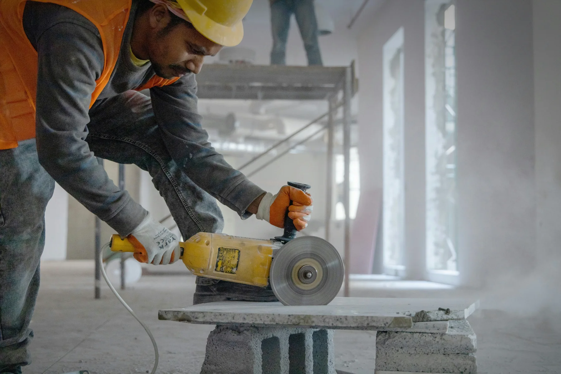 Construction worker cutting a concrete slab