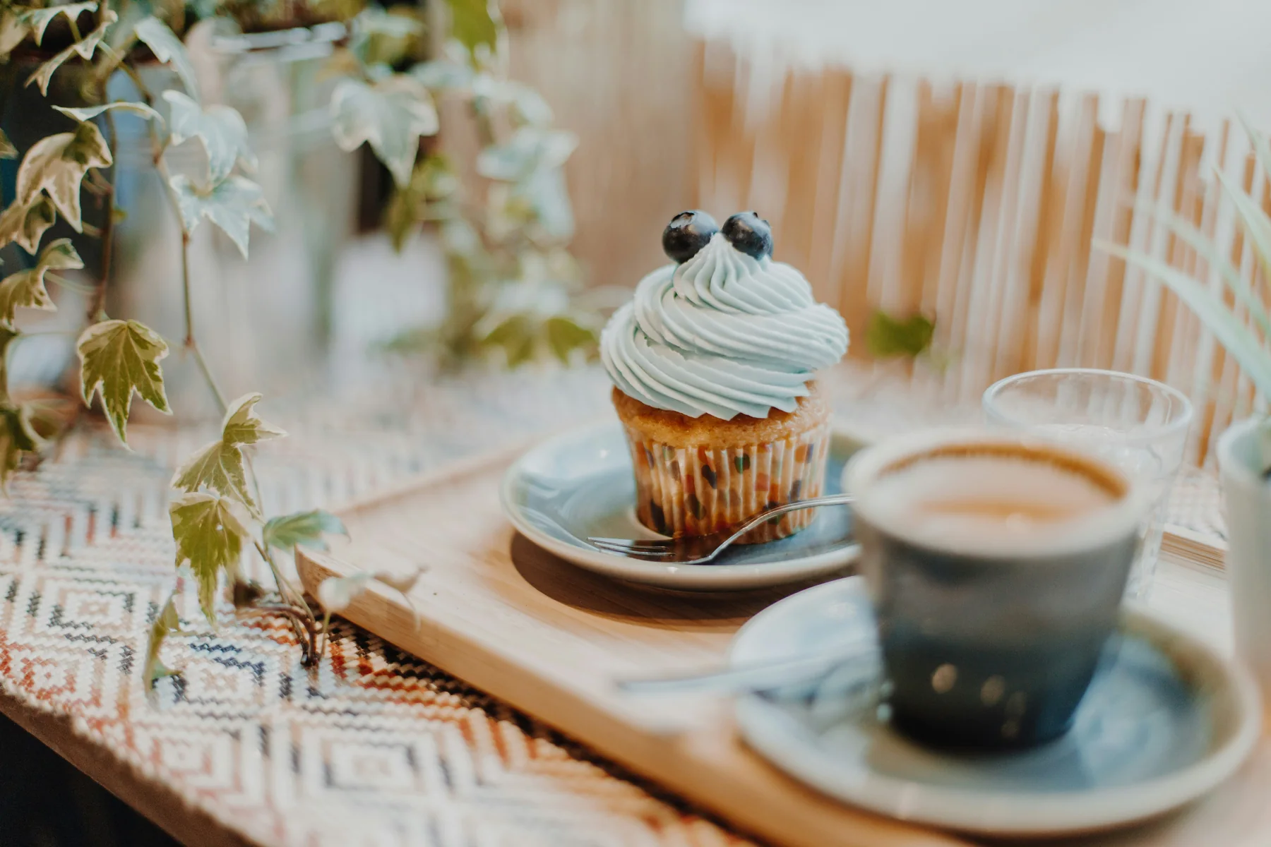 Coffee, cupcake and pastry served on a tray