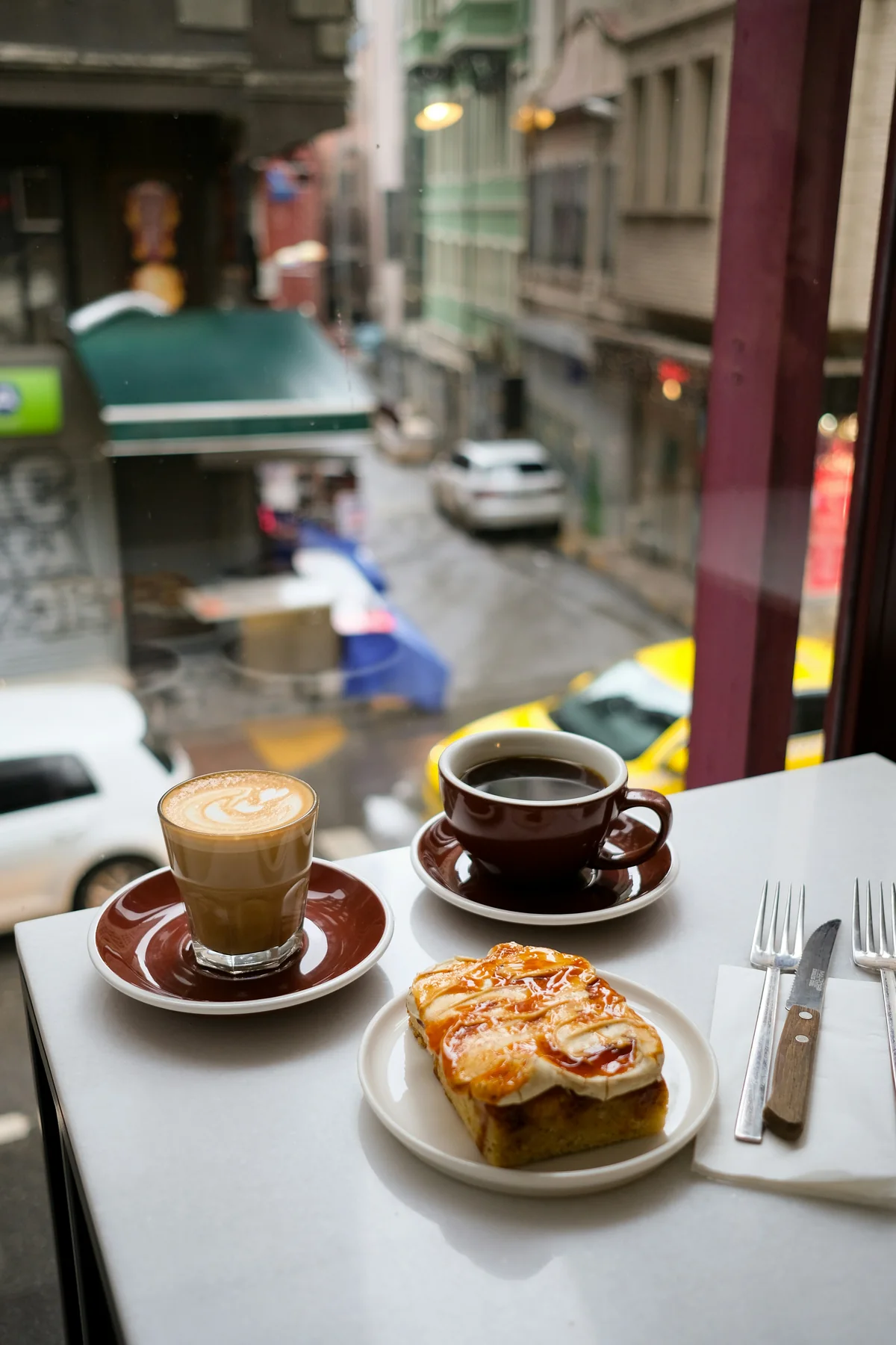 Coffee and pastry at a café window table